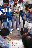 Men play Chinese checkers in a park in Hong Kong. China.