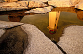 Lighthouse reflected in pond of water. Peggys Cove. Nova Scotia. Canada