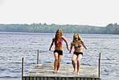 girl 13 girl 18 yrs about to jump into lake from dock