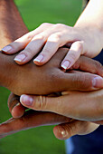 group of young adults stacking hands on top of each other
