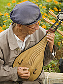 man performs on traditional instrument, Kunming, China