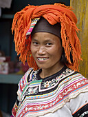 Yi woman with silver teeth in marketplace, Yuanyang, China