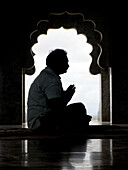 A man praying in a Kanifnath temple. Kanifnath (near Pune), Maharashtra, India