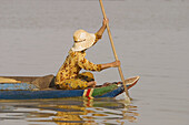 Asia, Cambodia, Lake Tonle Sap. Woman in to a small Fishing  boat