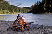 Camp fire on the shore of Tacu River. British Columbia. Canada