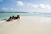 Venezuela, Los Roques, Crasquì Island, three girls on the beach.
