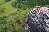 Two climbers on rock, Papststein, Saxon Switzerland, Saxony, Germany