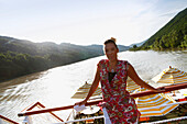 Woman standing on passenger ship, St. Martin, Upper Austria, Austria