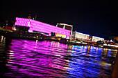 View over river Danube to illuminated Lentos Art Museum at night, Linz, Upper Austria, Austria
