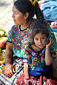 Maya woman and child at the local market, Antigua, Guatemala, Central America