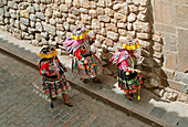 Inca women walking down a cobbled strret in Cusco, Peru, South America