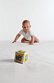 Baby crawling towards a toy