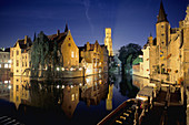 Canal scene with the Belfry in background. Brugge, Belgium