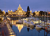 British Columbia Parliament buildings and inner harbour at dusk. Victoria, BC, Canada