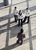 Three businesswomen and businessman standing vis-á-vis, Munich, Bavaria, Germany