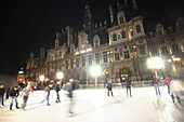 Ice skating in front of Town Hall Hotel de Ville, Paris, France