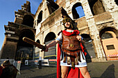 Man wearing uniform of Roman legionarie standing near Colosseum, Rome, Italy