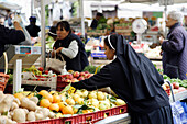 Nun at Fruit and veg stall on market, Campo de Fiori, Rome, Italy