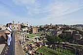 Couple enjoying view over Roman Forum, Rome, Italy