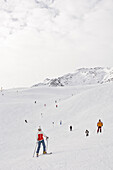 Female Ski driver is being fotographed on a ski piste, Schnalstal, south Tyrol, Italy