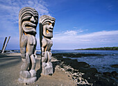 Wooden tikis in front of the Hale-o-Keawe Heiau (temple) at Pu'uhonua o Honaunau National Historic Park (City of Refuge), Kona Coast. The Big Island, Hawaii, USA (Oct. 2007)