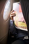 Man reading in plane