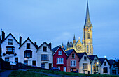 Europe, Great Britain, Ireland, Co. Cork, painted houses in the town centre of Cobh (West View), in the background St. Coleman's cathedral