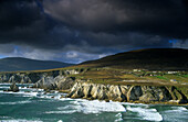 Surge in front of the steep coast under dark clouds, Achill Island, County Mayo, Ireland, Europe