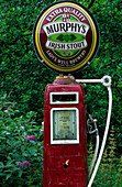 Old gas station, petrol station with Murphys beer sign on top near a pub in Lauragh on the Ring of Beara, County Kerry, Ireland, Europe