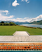 Terrace and garden of luxury Whare Kea Lodge in the sunlight, Lake Wanaka, Wanaka, Central Otago, South Island, New Zealand