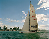 A sailing boat in front of the high rise buildings at Waitemata Harbour, Auckland, North Island, New Zealand