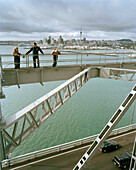 People on the steel arches of Harbour Bridge under clouded sky, Waitemata Harbour, Auckland, North Island, New Zealand