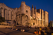 Tourists in front of the Palace of the Popes in the evening, Avignon, Vaucluse, Provence, France