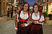 Italy Sardinia Olbia, women with traditional costumes on main street