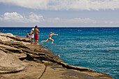 Tourists at Chinawall Rocks at Kawaihoa Point, Oahu, Pacific Ocean, Hawaii, USA