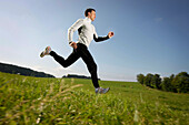 Man running over meadow