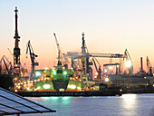 Illuminated shipyard at the harbour in the evening, Hanseatic City of Hamburg, Germany