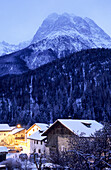 View over snow-covered Scuol at night, Lower Engadine, Engadine, Grisons, Switzerland