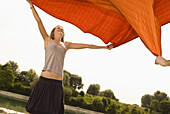 Teenage girl spreading out a blanket, Freising, Bavaria, Germany