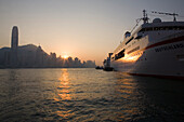 A ship and the Skyline of Hong Kong Island at sunset, Hong Kong, China, Asia