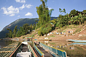 Boats at the bank of the river Nam Ou at the fishing village Muang Ngoi Kao, Luang Prabang province, Laos