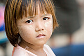 Face of a young burmese girl near Mount Popa, Myanmar, Burma