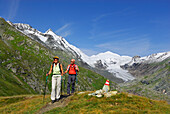 couple hiking on trail above glacier of Pasterze, Grossglockner and Johannisberg in background, Hohe Tauern range, National Park Hohe Tauern, Carinthia, Austria