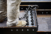 Construction worker boot standing on steel beam