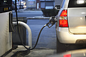 Gasoline hose at gasoline station filling up car