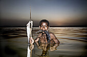 Boy fishing in Lake Awasa at sunset. South Ethiopia. African People