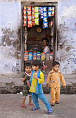 Children in front of shop, Allahabad. Uttar Pradesh, India