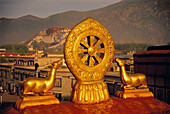 Roof of Jokhang temple with Potala palace in background, Lhasa. Tibet, China