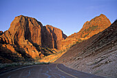 Sunset light on red rock sandstone cliffs above the Kolob Canyons Road, Kolob Canyons, Zion National Park, Utah, USA