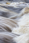 Close-up section of fast flowing river  Scotland  October